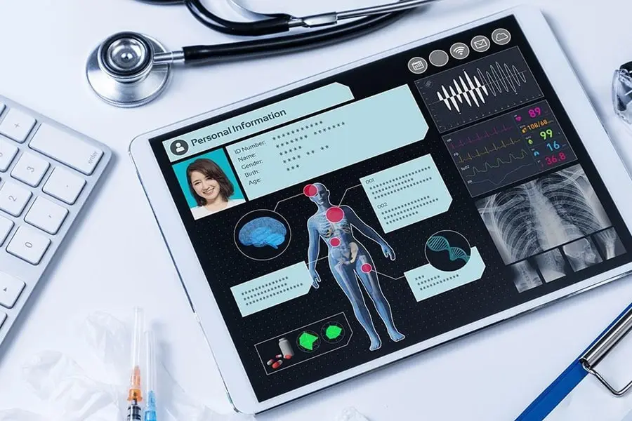 Tablet displaying patient’s medical data and personal information, alongside medical equipment.